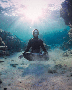 SurfEars ambassador Helena Bourdillon doing yoga and breath work under water.